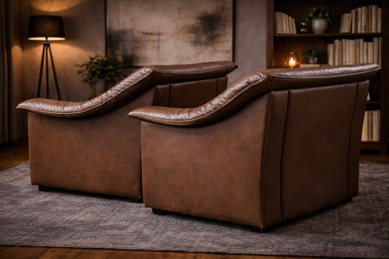 Image 1 of Pair of mid‑century brown leather club armchairs in good condition with small signs of aging and blemishes