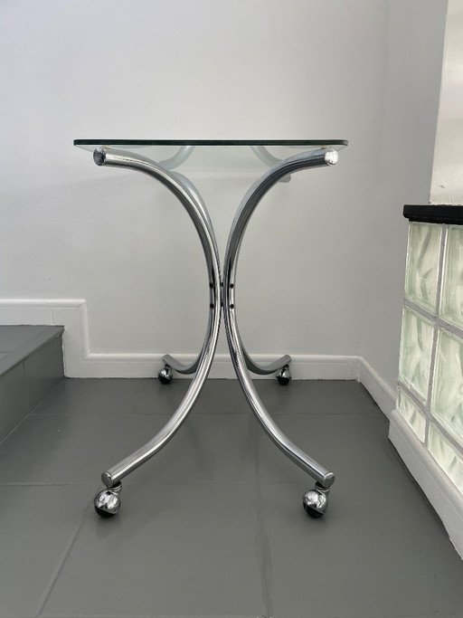 Salontafel van chroom en glas met wielen