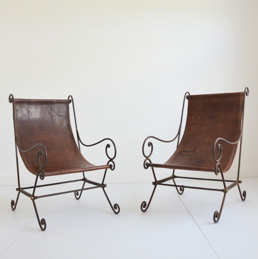 Pair of wrought iron and vintage leather armchairs
