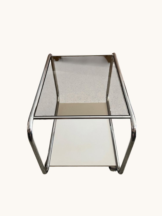 Image 1 of Vintage Space Age side table made of chrome and smoked glass. Sculptural 70s design with wheels.