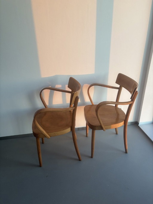 2x wooden vintage chairs with curved design