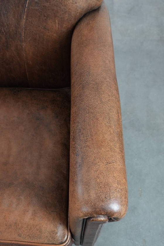 Image 1 of 2 x Vintage sheepskin armchair with warm colours and a characterful appearance