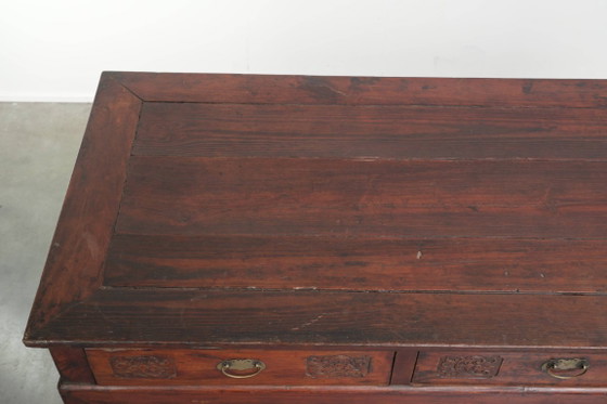 Image 1 of Antique wooden Chinese sideboard from the late 19th century in a beautiful red color with exquisite wood carving.