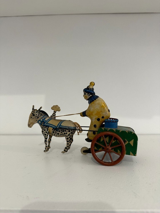 Image 1 of Jouet ancien en tôle lithographiée – Char à âne conduit par un clown