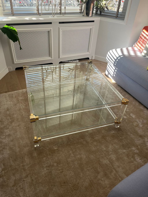 Mid-century glass coffee table with brass accents