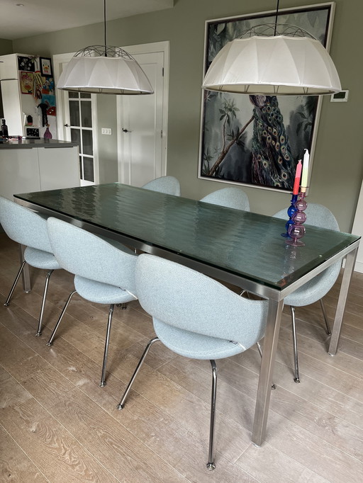 Dining table Metaform S-16. Stainless steel frame with brut glass top