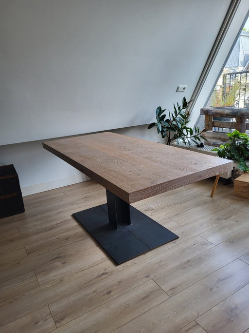 Wooden table with cast iron leg