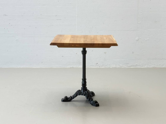 Image 1 of Bistro table made of acacia wood with a cast iron base in country style