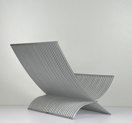 UMBRA book/magazine holder made of brushed aluminum slats. Foldable designer MICHELLE IVANKOVIC