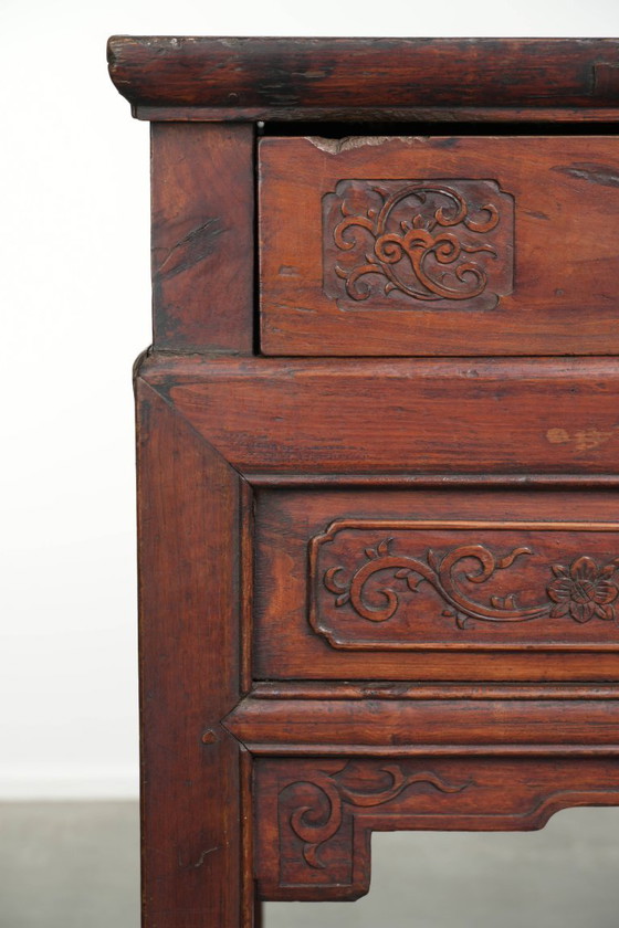 Image 1 of Antique wooden Chinese sideboard from the late 19th century in a beautiful red color with exquisite wood carving.