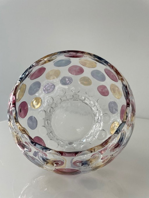 Decorative glass jar with colorful polka dots design