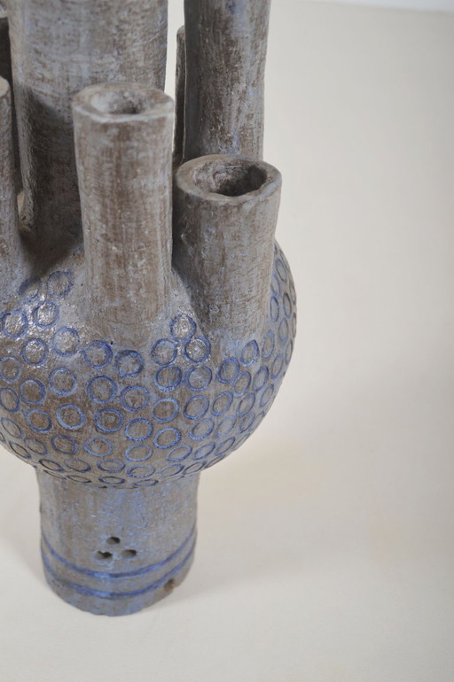 Ceramic sculpture with circular patterns and signature