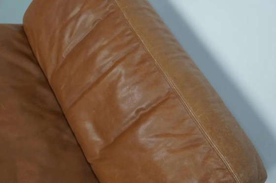 Image 1 of De Sede DS 76 loungestoel / slaapbank van cognackleurig leer, Zwitserland, jaren 1970