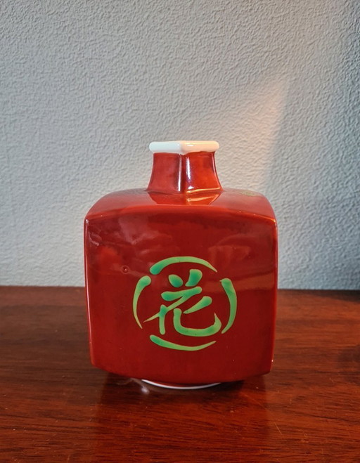 Old Arita porcelain vase in vermilion with the words "flowers, birds, wind and moon".