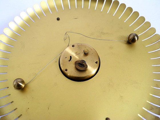 Image 1 of Beautiful original Mid Century Sunburst Atlanta Universe wall clock made of heavy brass with a mechanical seven-day movement