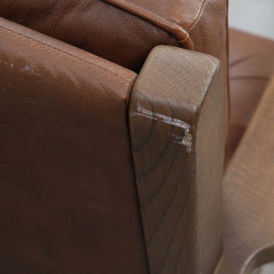 Image 1 of A vintage brown three-piece sofa set in leather with wooden armrests and turned legs, comprising a 1-seater, 2-seater and 3-seat