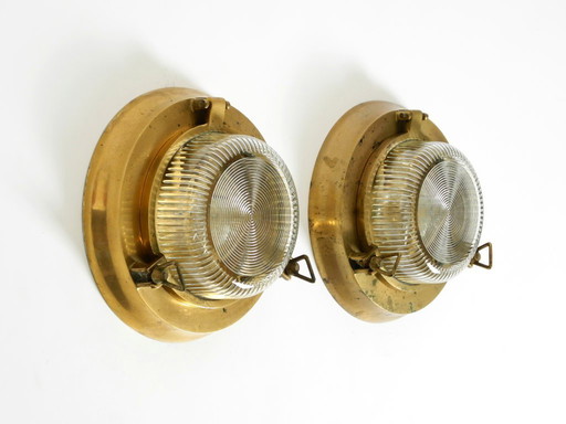 A pair of large, heavy 1950s original maritime ship wall lamps made of brass and glass