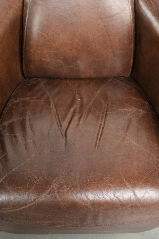 Image 1 of Karaktervolle en stoere donker cognac bruine rundleren Aviator design fauteuil/ armchair met een interessante vorm