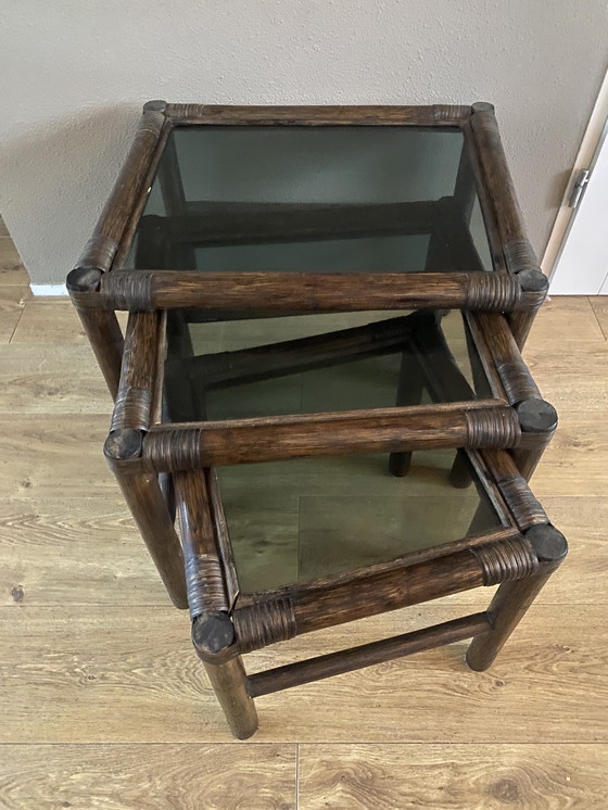 Image 1 of Vintage rattan bamboo nesting tables mimeset smoked glass