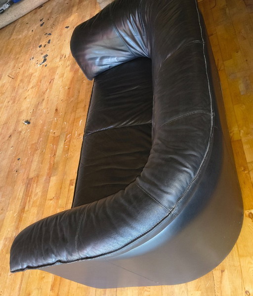 Two identical, black, leather Leolux sofas