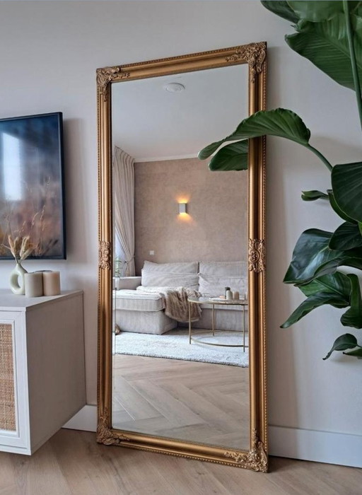 Espejo grande de bronce dorado con aspecto antiguo y facetado