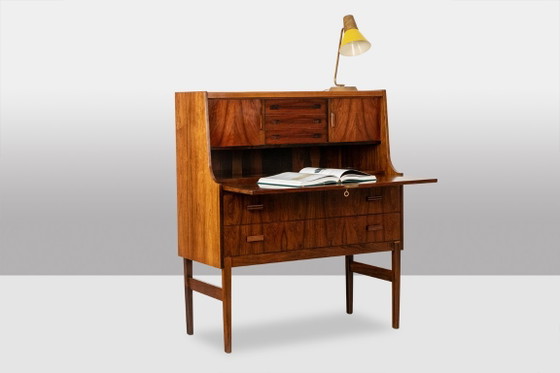 Image 1 of Commode van palissanderhout met 2 laden, die tevens als secretair dient. Jaren 70.