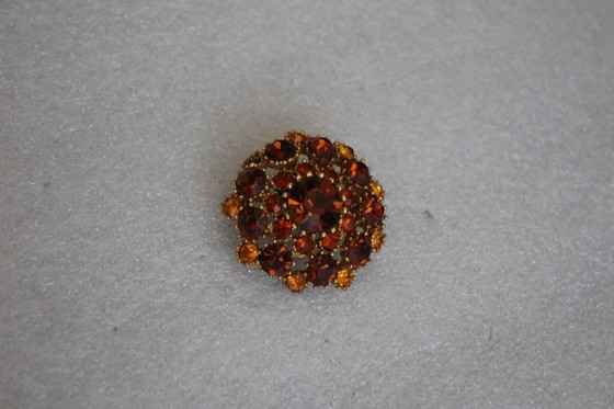 Image 1 of Vintage costume jewelry brooch with amber rhinestones, marked SPHINX