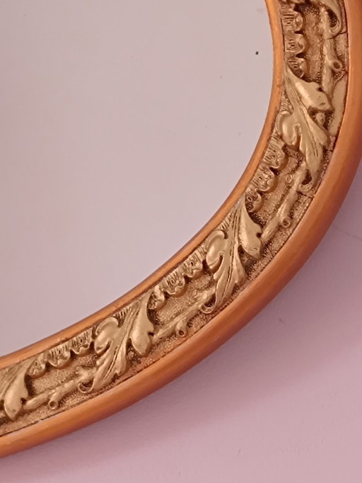 Oval mirror with gold and ornate frame