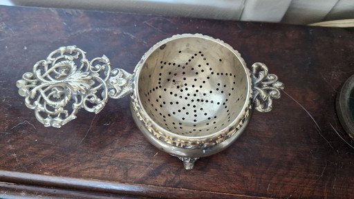 Antique tea strainer and drip tray. Silver-plated?