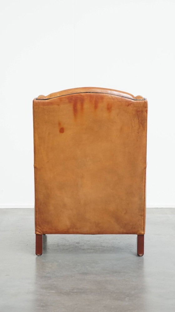 Image 1 of Schapenleren armchair met hoge rug en zwarte biezen 