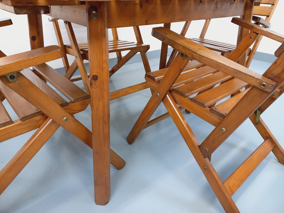 Image 1 of Vintage garden furniture consisting of a table with extensions and 4 wooden armchairs from the 60s