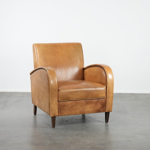 Luxurious armchair made of cowhide leather with a beautiful warm color scheme