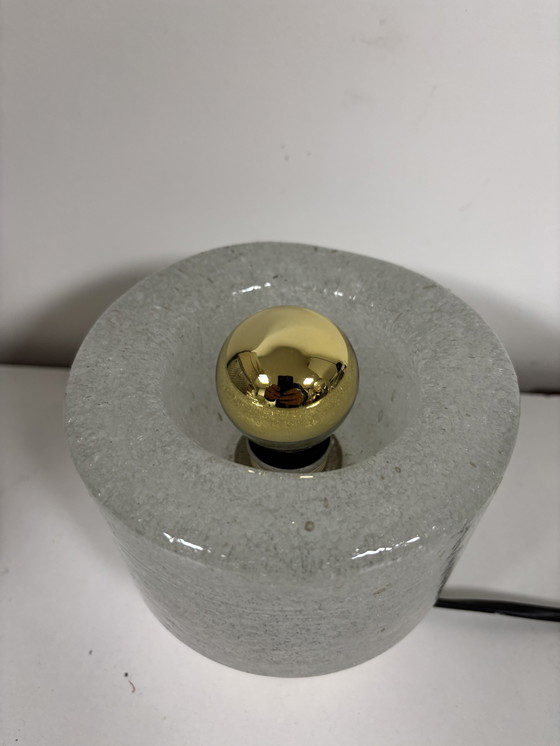 Image 1 of vintage table lamp by Peill & Putzler is made of thick ice glass with brass details