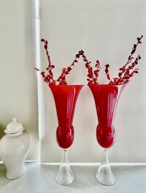 2 red and white vases with 5 decorative branches made of glass