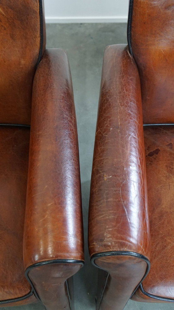 Image 1 of 6 x Vintage sheepskin dining chair with black piping on wheels