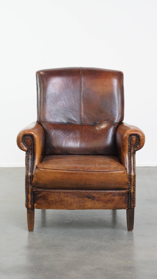 Vintage sheep leather armchair with a high back