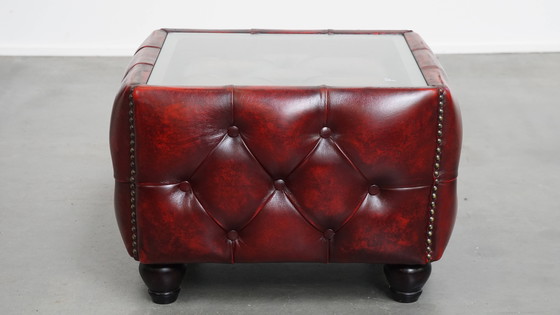 Image 1 of Beef leather chesterfield side/ coffee table in a red color with glass top