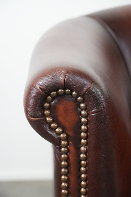 Image 1 of 2 poltrone club in pelle bovina in buone condizioni, di un lussuoso colore rosso/marrone.