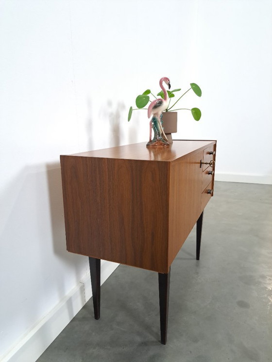 Image 1 of Mid-Century teak kastje op hoge zwarte poten met lades