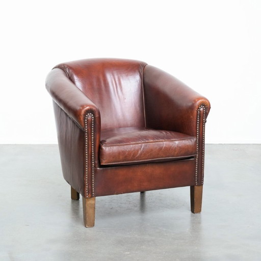 Vintage clubfauteuil gemaakt van schapenleer met siernagels