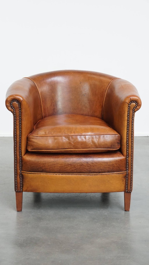 In good condition club chair made of sheep leather