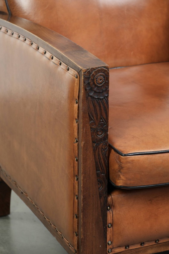 Image 1 of Unieke schapenleren art Deco fauteuil met mooi houtsnijwerk en zwarte biezen