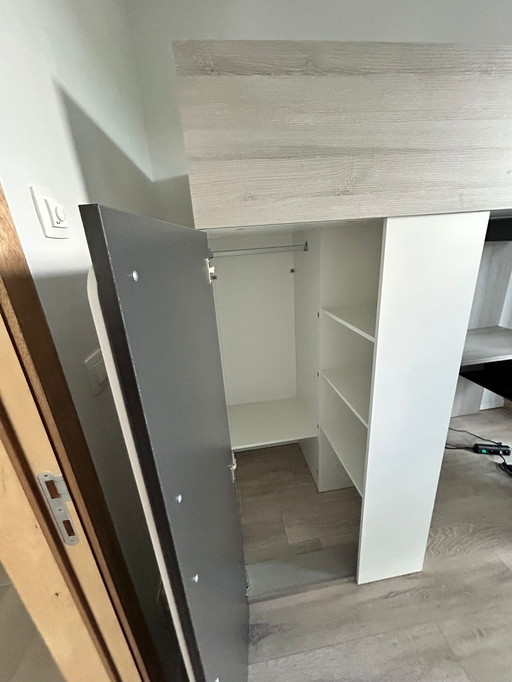 Loft bed with integrated wardrobe and desk