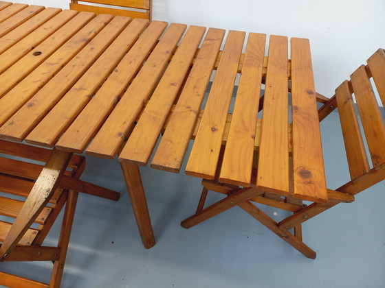 Image 1 of Vintage garden furniture consisting of a table with extensions and 4 wooden armchairs from the 60s
