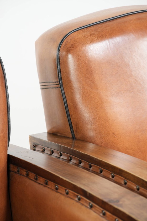 Image 1 of 2 x Prachtige schapenleren Art Deco fauteuil met mooi houtsnijwerk en zwarte biezen