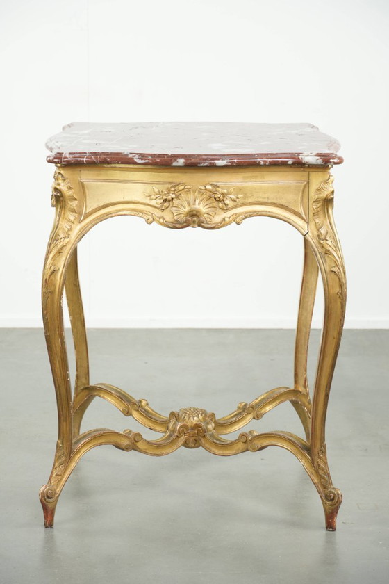 Image 1 of Antique French side table/center table from the 19th century with a gold-colored wooden frame and an original marble tabletop.