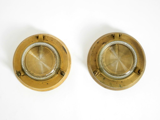 A pair of large, heavy 1950s original maritime ship wall lamps made of brass and glass