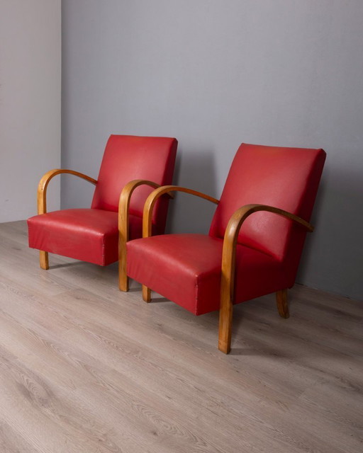Coppia di poltrone vintage anni '50 in pelle rossa, design italiano.