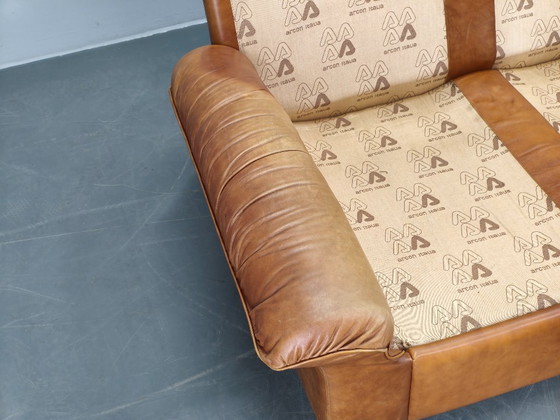 Image 1 of Arcon Italia driezitsbank uit de jaren 70, bekleed met cognacbruin buffelleer.