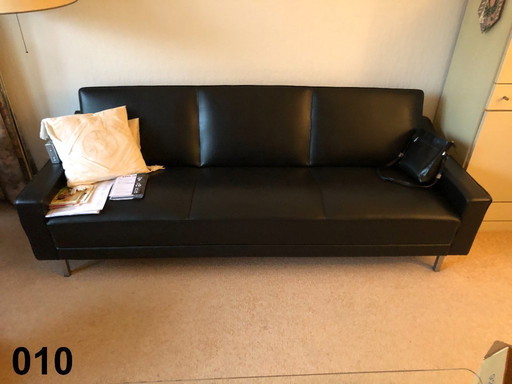 modern three-seater sofa in black imitation leather/leather look